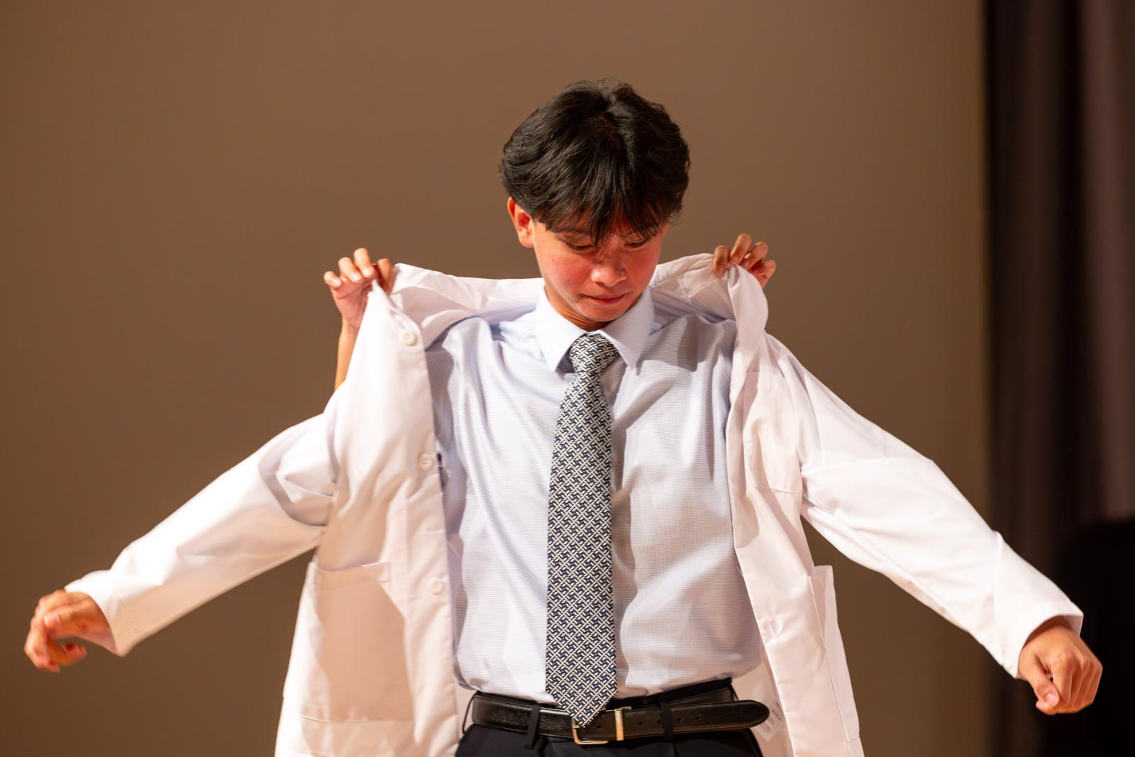 a nursing student receiving their white coat
